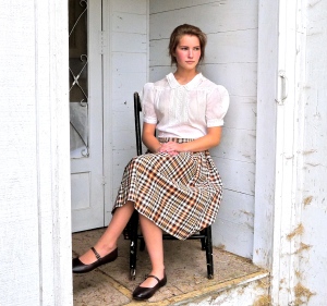 Mia on a back porch modeling 1930s blouse and 1950s skirt.